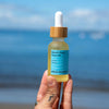 Fresh Pickins Farm Beach rose face oil at the beach in maine
