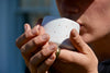 person drinking herbal tea from mug close up