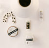 Collection of skincare products with a white mug on a light background