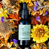1oz Bottle of Fresh Pickins Farm Wild Chaga Extract surrounded by dried flowers and herbs