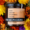 Jar of Fresh Pickins Farm Raw Maine Blueberry against a floral background