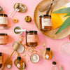 Fresh Pickins Farm Honey products, including jars, a honey dipper, and honeycomb on a pink background