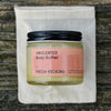 Fresh Pickins Farm Organic Unscented body butter jar with pink label on a white cloth against a wooden background