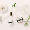 Skincare products with rosemary leaves on a white background