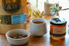 herbal tea and raw Maine honey on table with loose leaf tea
