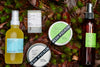 Collection of Fresh Pickins skincare products on a natural background with leaves and moss.
