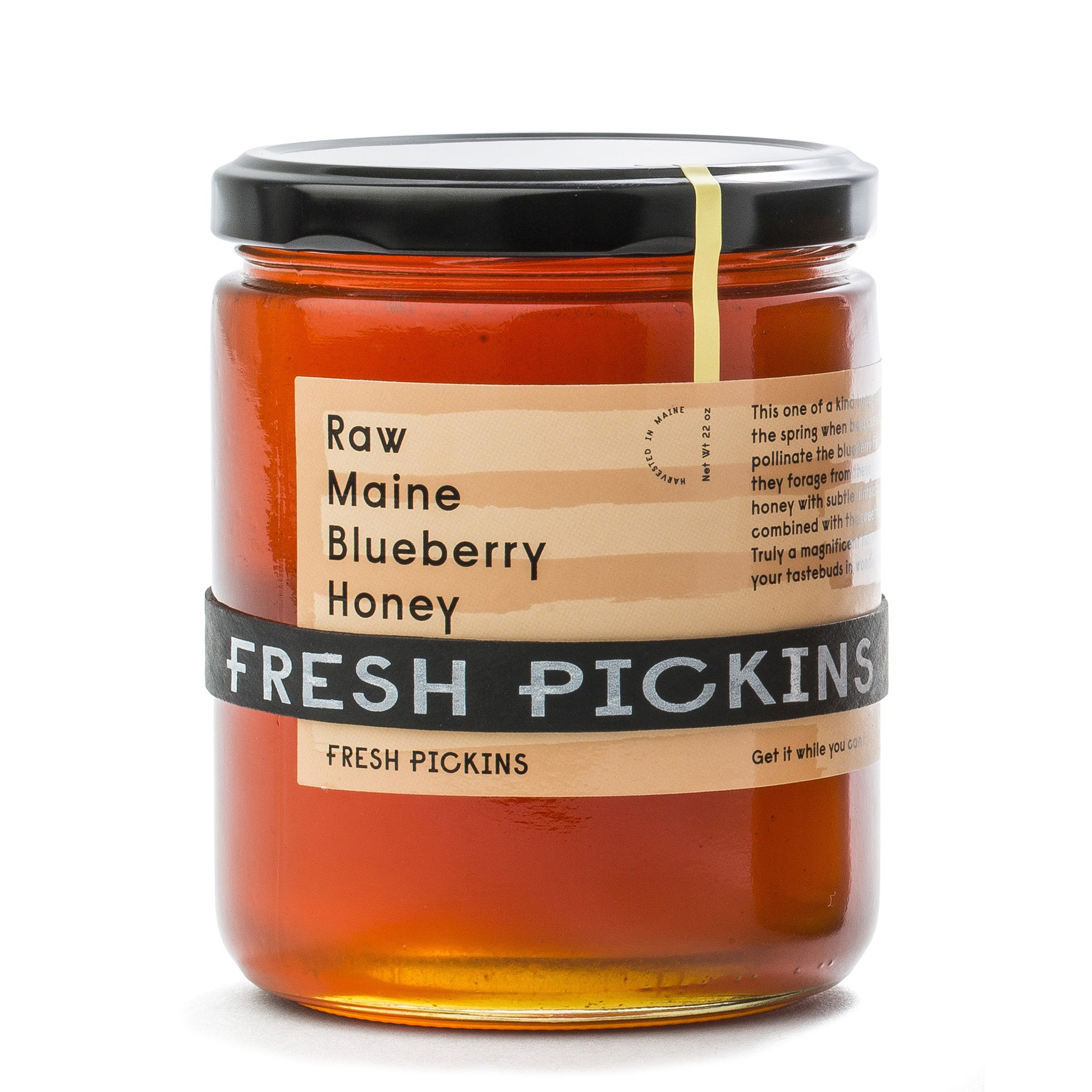 A jar of Fresh Pickins Farm raw Maine blueberry varietal honey in a glass jar.