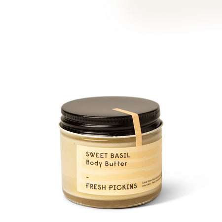 A jar of body butter labeled SWEET BASIL Body Butter by Fresh Pickins Farm in Maine.